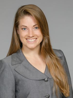 Head shot of Neva Lundy in business attire, smiling at camera