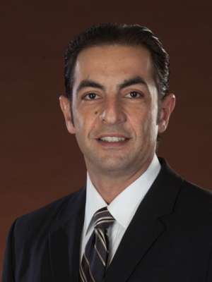 Person in dark suit and striped tie