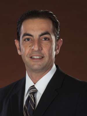 Person in dark suit and striped tie