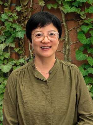 Headshot of Jieping Yang wearing glasses and a green blouse