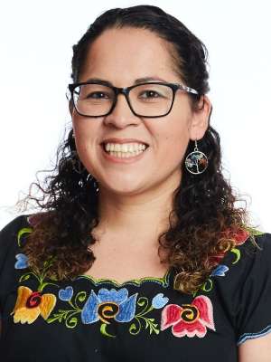 headshot of Cynthia Gonzalez in traditional floral shirt