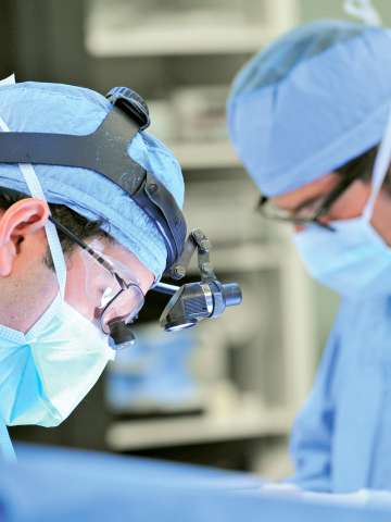 Surgeons operating on a patient in surgery