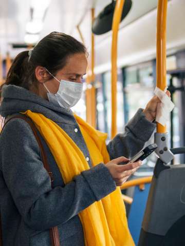 Woman on bus with mask on