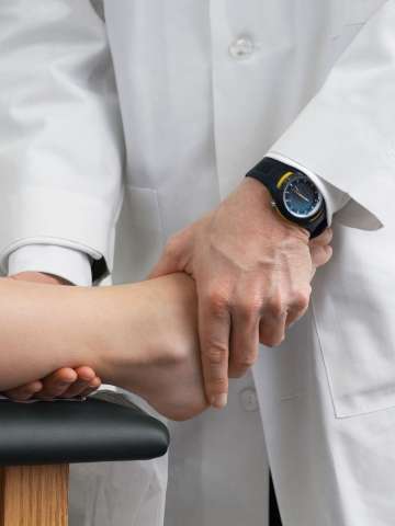 Doctor examining patient's feet and ankle