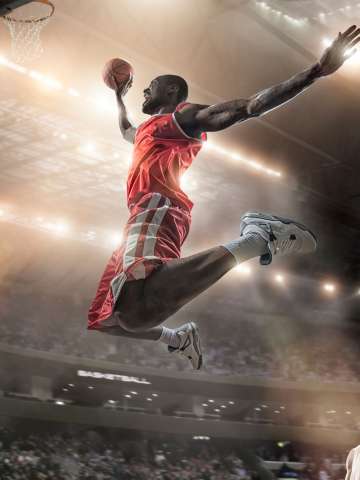 Basketball player jumping in mid air