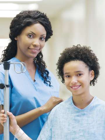 Doctor and patient with IV in hospital corridor