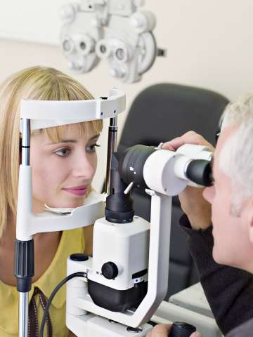 Ophthalmologist giving patient eye exam