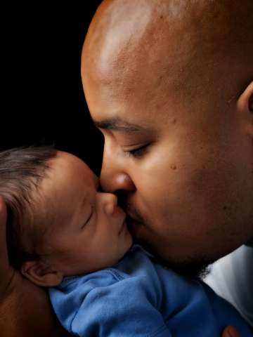 Father kissing baby