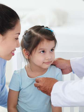 Mother and daughter with a physician