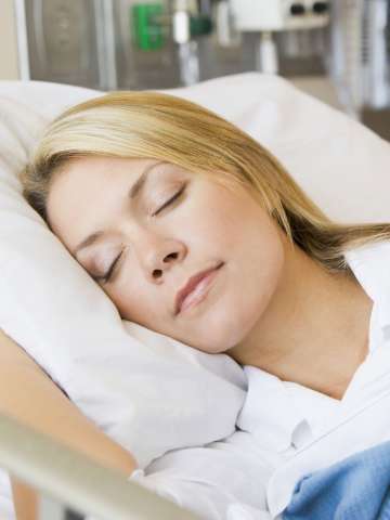 Woman sleeping in a hospital bed
