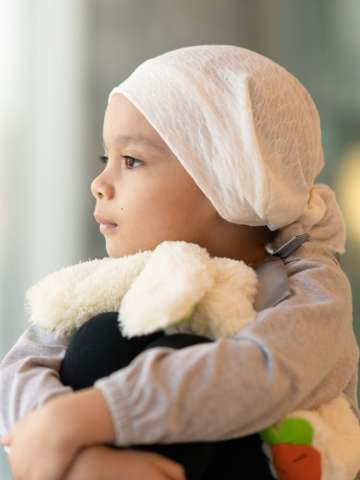A beautiful little girl with cancer takes a break from treatment.
