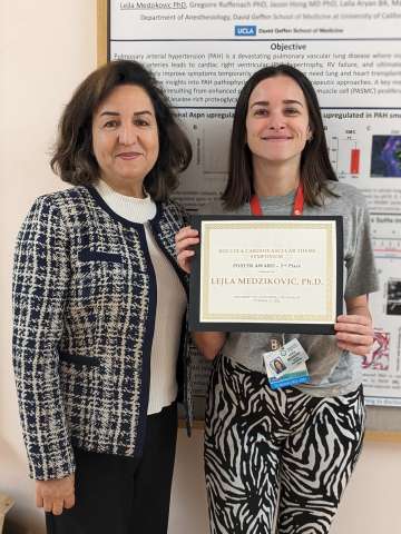 Lejla Medzikovic holding her second place certificate alongside Mansoureh Eghbali, PhD