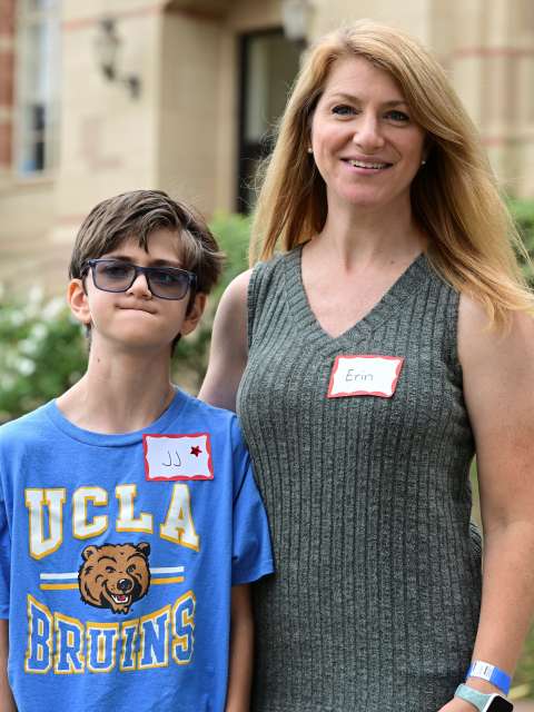 A boy stands with his mother at the UCLA NICU Reunion.