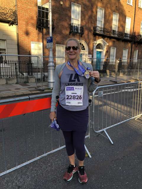 A runner stands at the finish line of the Dublin Marathon.