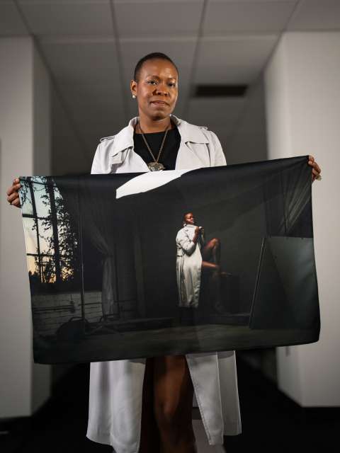 Melissa Watkins holds a portrait of herself embodying the stage of depression. (Photo by Nick Carranza)