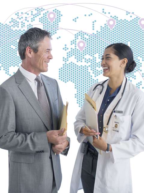 A businessman and doctor in front of a world map graphic.