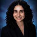 Dr. Nicki Karimi-Mostowfi in a black suit jacket smiling at the camera