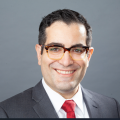 Headshot of Dr. Hugo Torres in gray suit