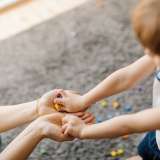 Child with hands in adult's hands