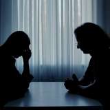 Silhouette of two people talking.