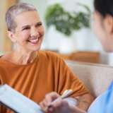 A cancer survivor meets with her doctor.