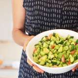 Eve's Cave Salad - Holding a Bowl in the Kitchen