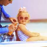 child having sunscreen applied