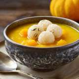 Korean Pumpkin Porridge in bowl Next to Squash