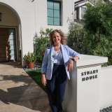 Dr. Jane Halladay Goldman stands in front of Stuart House.