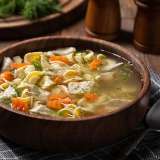 Chicken Noodle Soup in a Wooden Bowl