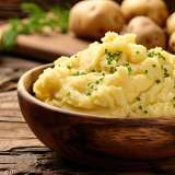 Mashed Potatoes in Wooden Bowl on Wooden Table