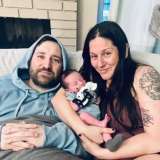 KC Brandenstein and husband, Jason Benoit, at home with their newborn daughter, James.