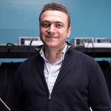 Midrange photo of Aydogan Ozcan in light blue button-down and dark blue zip-up cardigan