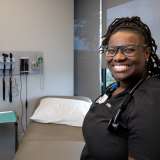 Black female doctor in examination room