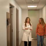 Dr. Farnaz Haji and patient Heather Hatchman, a Ventura elementary school teacher, walk together down a clinic hallway.