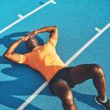 exhausted athlete on track after intense training