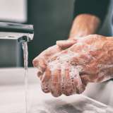 Man washing his hands in soap and water