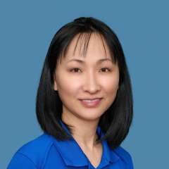 Michelle Tan wearing a blue collared shirt with UCLA logo
