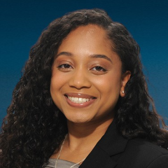 Head shot of Rehana Persaud in business attire smiling at the camera