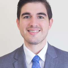 Marcos Estrada Rodriguez, MD headshot, wearing a suit and tie