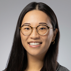 Head shot of Joyce Lee in business attire, smiling at the camera