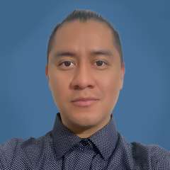 headshot of Rolando Kok in polka-dot button-down shirt