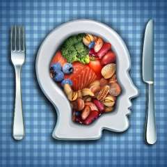 Head-shaped plate with salmon, berries, nuts and vegetables
