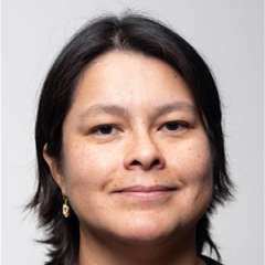 headshot of Sara Flores in black blouse