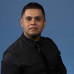 headshot of Ernesto Lopez in black shirt