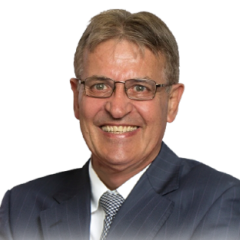 Headshot of Dr. Andre Nel in a suit and tie, wearing glasses, looking confidently towards the viewer.