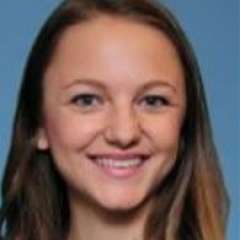 headshot of Dr. Rebecca Nayeri with a blue background