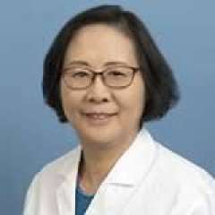 Dr. Lu Song with glasses and a warm smile wears a white lab coat, conveying a sense of approachability and professionalism.