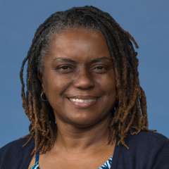 headshot of Jacqueline Pious Gaines in black cardigan