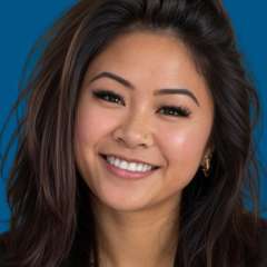 headshot of Karmel Bas with a blue background